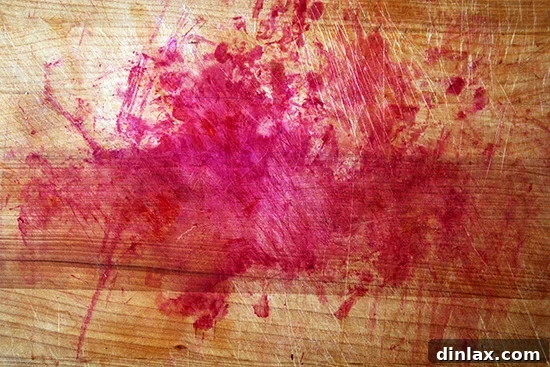Cutting board stained by beet juice, a reminder to use a protective surface.