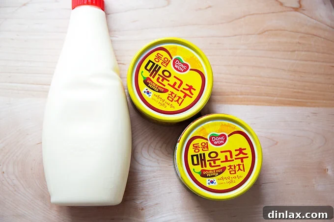 Korean Fire Tuna Crostini 3 Essential ingredients for Korean Double Hot Tuna: Two tins of spicy Korean tuna and a bottle of creamy Kewpie mayonnaise.