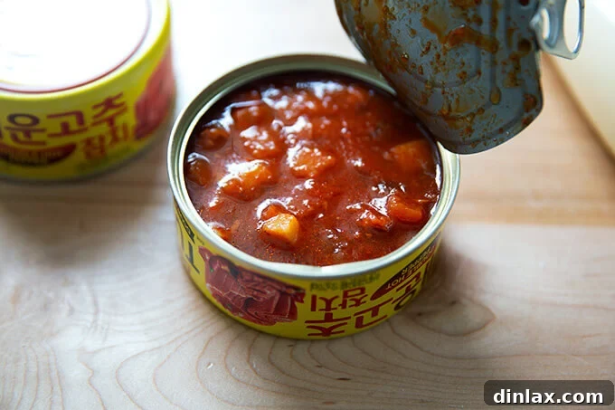 Korean Fire Tuna Crostini 4 An opened tin of Korean double hot tuna, revealing its vibrant, spicy contents infused with tomato and red pepper.