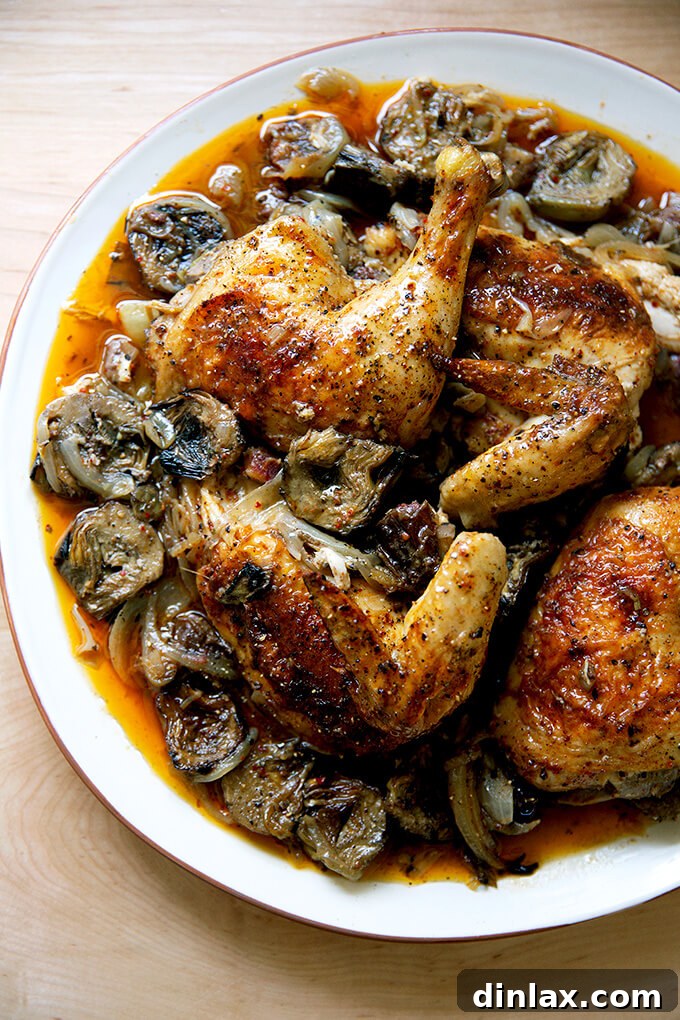 A beautifully presented platter of roast chicken with dates and artichoke hearts, garnished with fresh herbs, ready for a festive table.