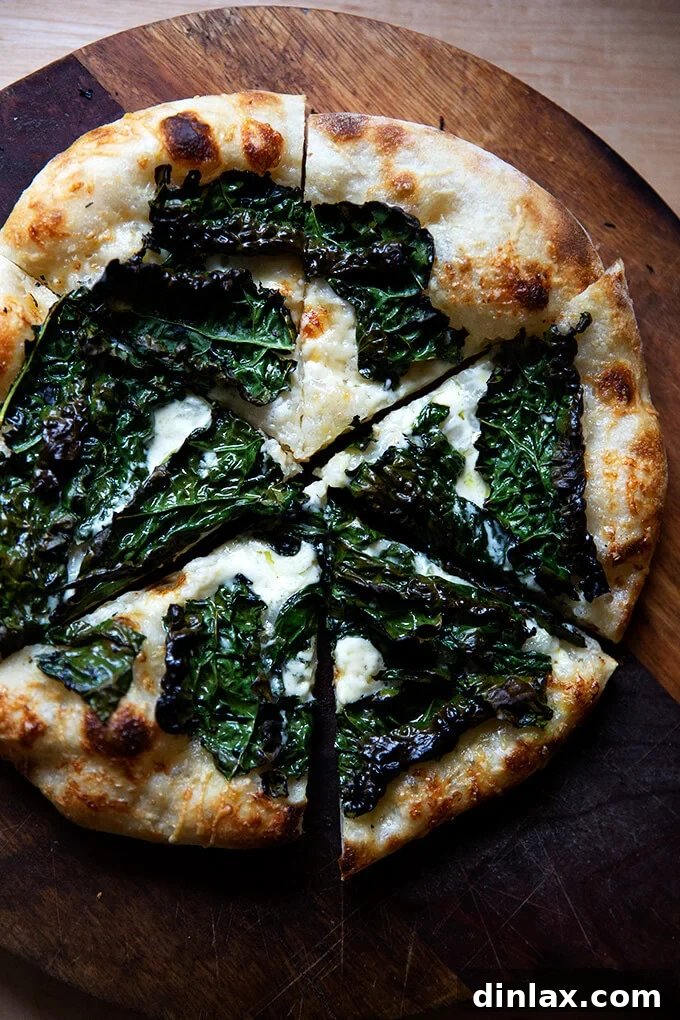 Unlock the Best Sourdough Pizza Crust 21 Sourdough kale and creme fraiche pizza on a board, cut into pieces.