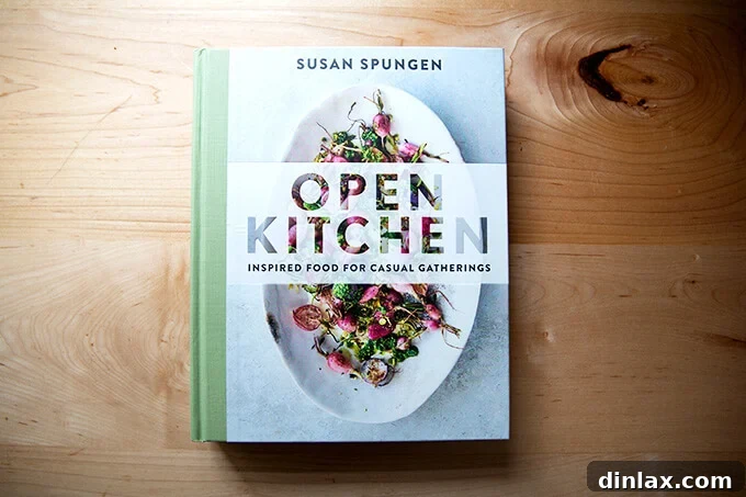 A beautifully designed cookbook, Open Kitchen by Susan Spungen, displayed elegantly on a kitchen counter.