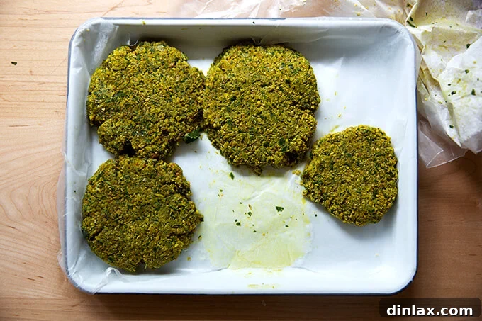 A tray filled with neatly arranged, individually frozen falafel burgers, ready for long-term storage.
