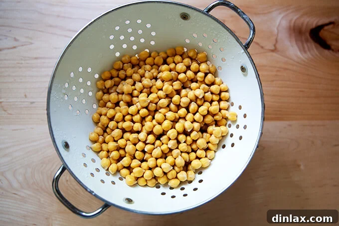 Drained and rinsed chickpeas in a colander, glistening and ready for the next step.