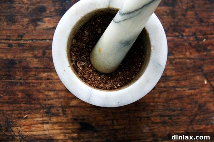 Ground cumin and coriander seeds in a mortar and pestle.