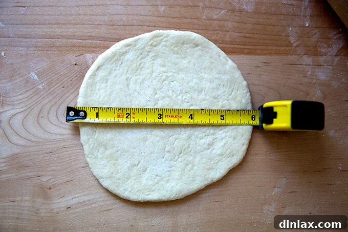 Your Guide to Irresistible Homemade Pita 16 A round of uncooked pita bread meticulously rolled to 6 inches in diameter.
