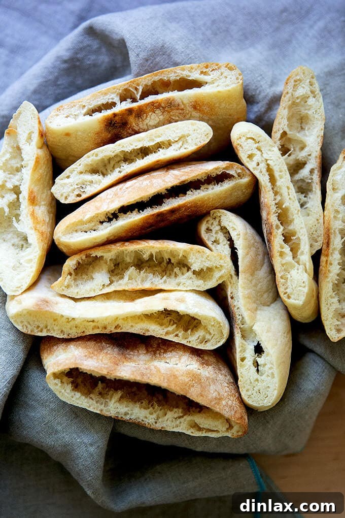 Your Guide to Irresistible Homemade Pita 21 A bowl of cut open rounds of pita bread, ready for serving.