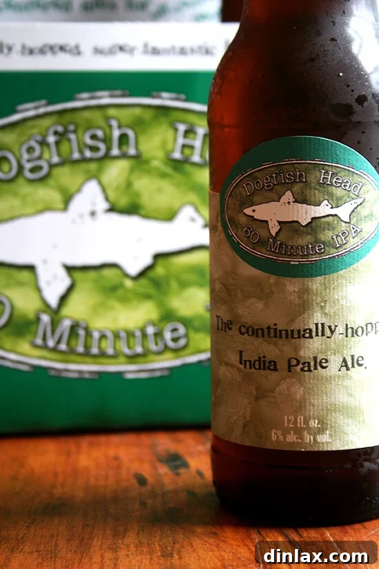 Enjoying Dogfish Head 60 Minute IPA, a staple for any craft beer enthusiast's summer menu. Two chilled pint glasses filled with amber Dogfish Head 60 Minute IPA, showcasing its inviting color.