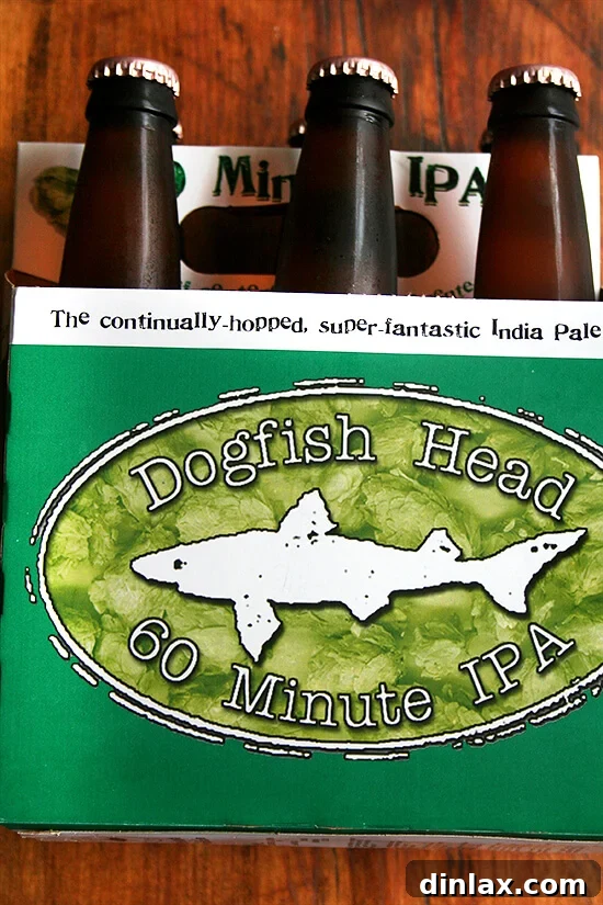 Dogfish Head 60 Minute IPA: The perfect craft beer for summer celebrations and grilling. A refreshing glass of Dogfish Head 60 Minute IPA, perfectly poured with a creamy foam head, ready for enjoyment.