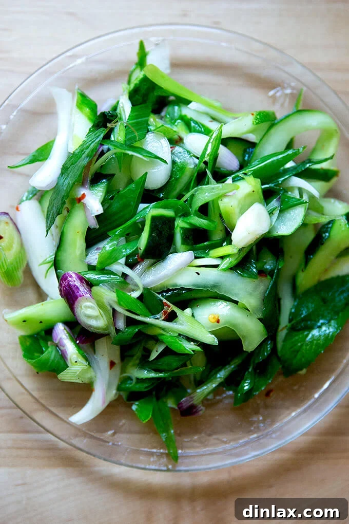 A portion of the fresh cucumber salad beautifully plated, ready to be enjoyed.