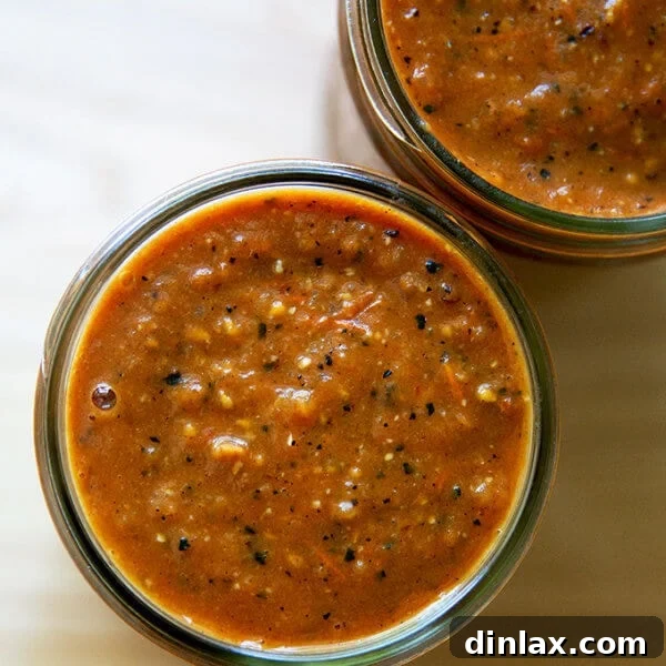 An overhead shot of quick red enchilada sauce in a jar.