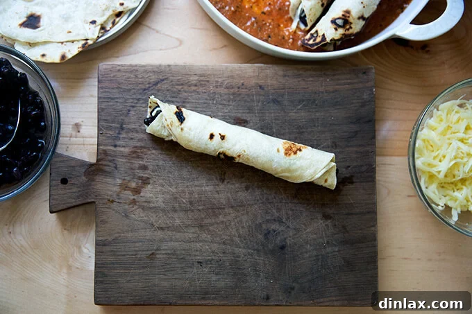 Ultimate Vegetarian Bean and Cheese Enchiladas 5 A single flour tortilla, filled with black beans and Monterey Jack cheese, perfectly rolled into a coil.