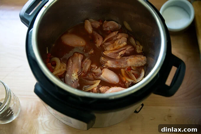 Smoky Instant Pot Chicken Tinga 8 Chicken thighs added to the Instant Pot.