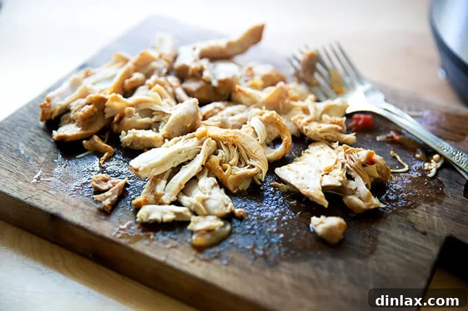 Smoky Instant Pot Chicken Tinga 10 Shredded chicken tinga on a board.