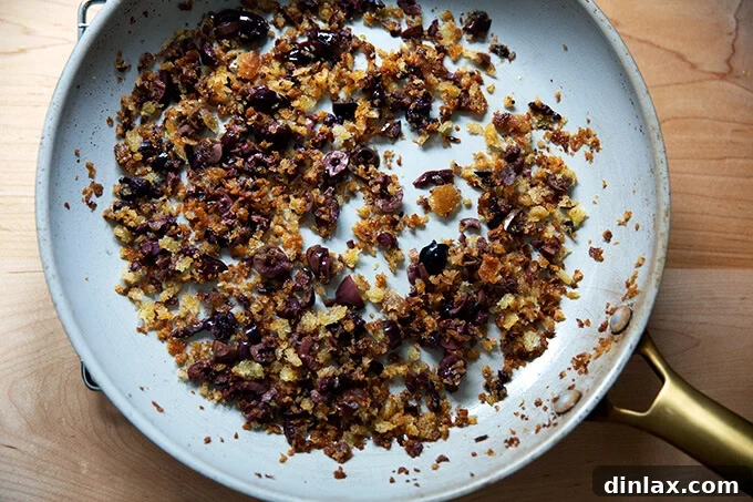 Olive bread crumbs in a skillet.