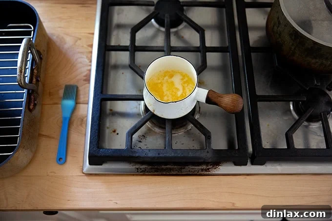 Melted butter in a small bowl.
