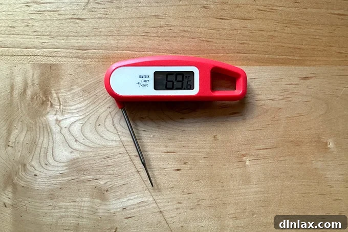 Preparing the dry-brined turkey for roasting, ready to be seasoned with butter, salt, and pepper.