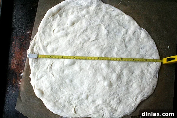 A pizza dough ball being measured, demonstrating the desired size for individual pizzas.