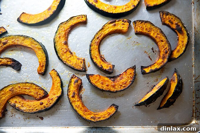 Roasted kabocha squash on a sheet pan.