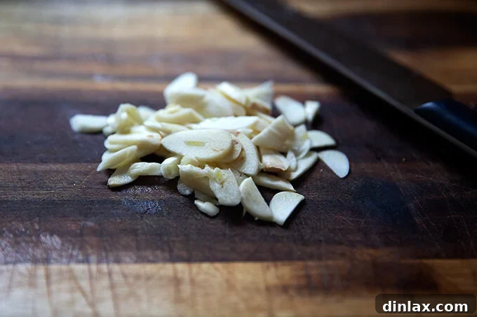 Sliced garlic on a cutting board.
