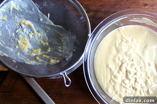 Straining the Custard Straining the warm butterscotch custard through a fine-mesh sieve for a perfectly smooth texture.