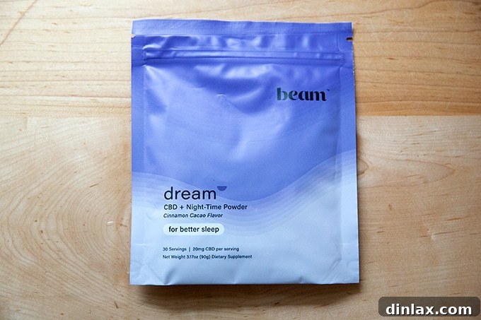 The 2021 Holiday Gift Edit 30 A bag of Beam Dream sleep powder next to a cup of warm, comforting beverage.