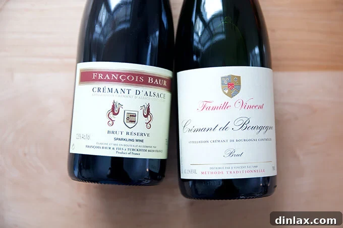 Two elegant bottles of Crémant, a sparkling wine alternative to Champagne.