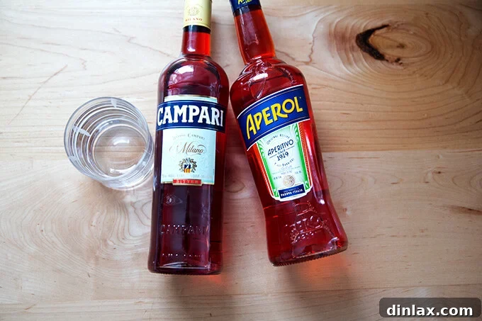 Side-by-side bottles of Campari and Aperol, two popular red bitter apéritifs.
