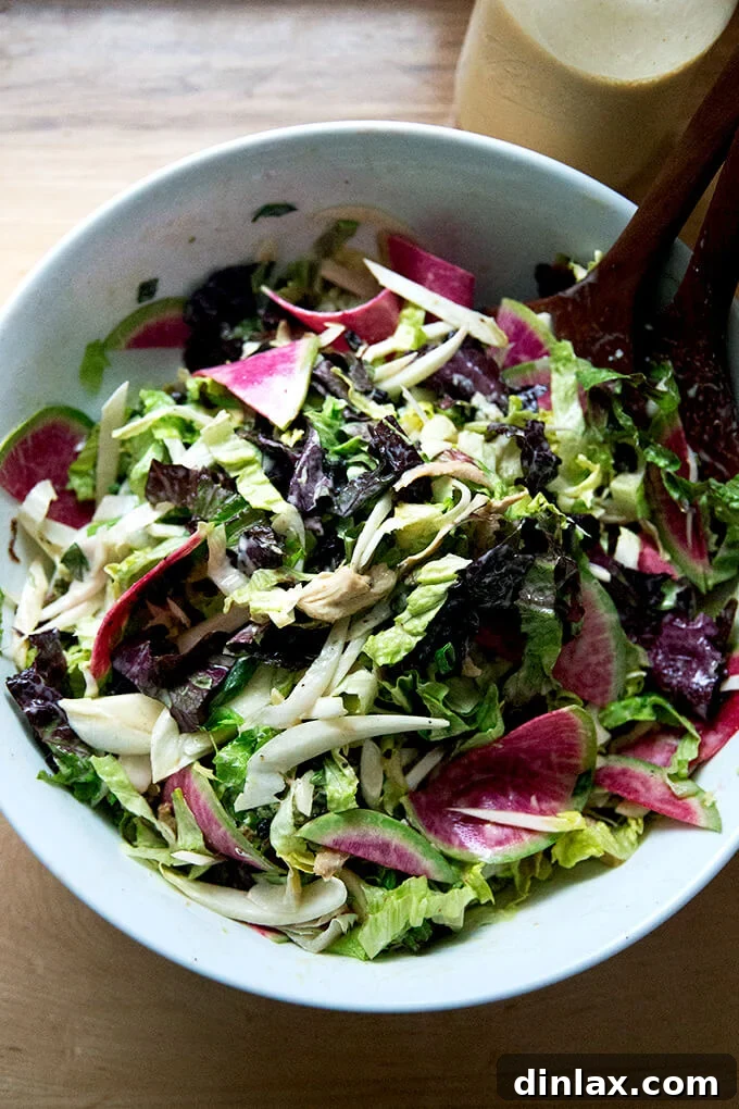 A large chopped salad tossed with tahini dressing.