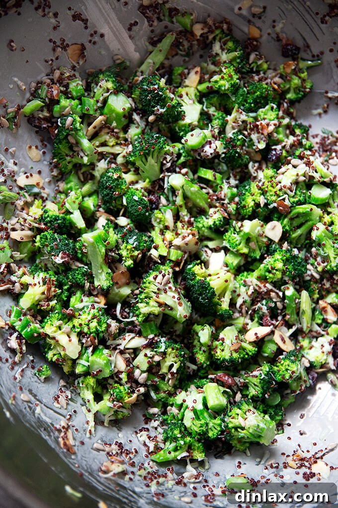 A large serving bowl filled with the vibrant, fully tossed Broccoli-Quinoa Crunch Salad.