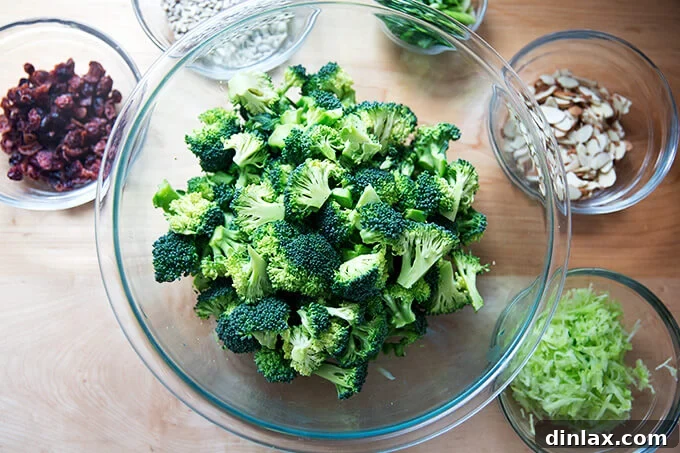 Assortment of prepped ingredients including chopped broccoli, grated stems, and sliced scallions.