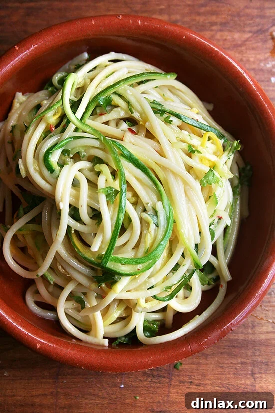 A close-up of summer squash spaghetti with lemon zest and parmesan
