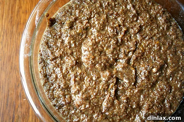 Delicious bran muffin batter, perfectly mixed Thick, rich bran muffin batter in a mixing bowl, showcasing its consistent texture.