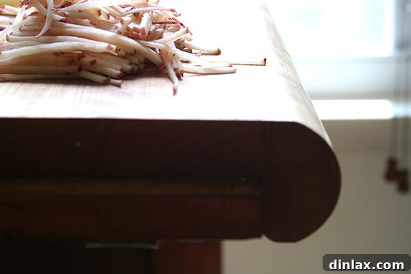 A wooden cutting board with a raised ledge, ideal for securing a mandoline