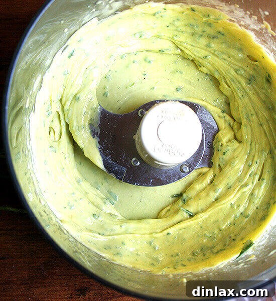 A bowl of freshly made, creamy homemade mayonnaise, highlighting its smooth texture and rich color. A perfect base for various dressings.