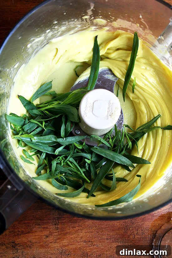 A bunch of fresh tarragon, its delicate leaves ready to infuse flavor into the mayonnaise.