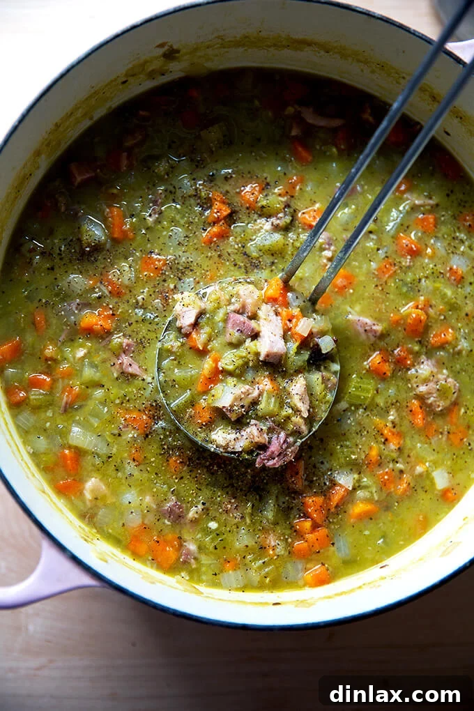 A large pot of perfectly seasoned split pea and ham soup, with a ladle resting invitingly, ready to be served and enjoyed.