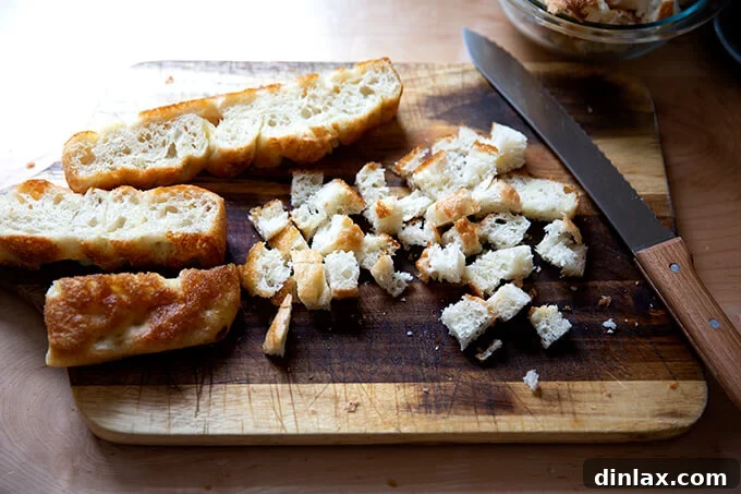 Stale focaccia bread, perfectly cubed and ready to be transformed into crispy, golden croutons for the soup.