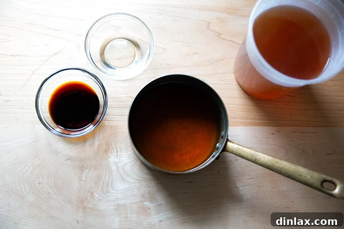 Udon: A Culinary Revelation 3 A simple yet potent broth brewing with vegetable stock, soy sauce, and mirin, ready to become the soul of the udon noodles.