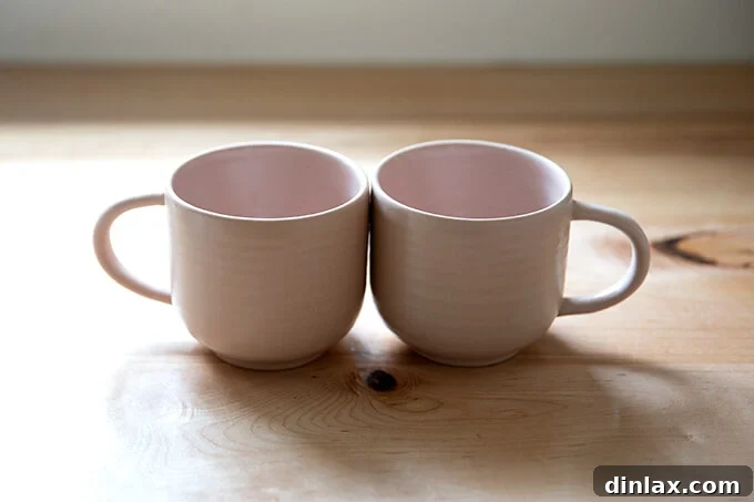 Two charming pink mugs, an ideal Mother's Day gift for her morning coffee.