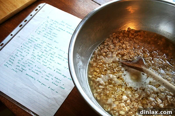 Oats, brown sugar, and butter soaking in a bowl, the first step for no-knead oatmeal bread.