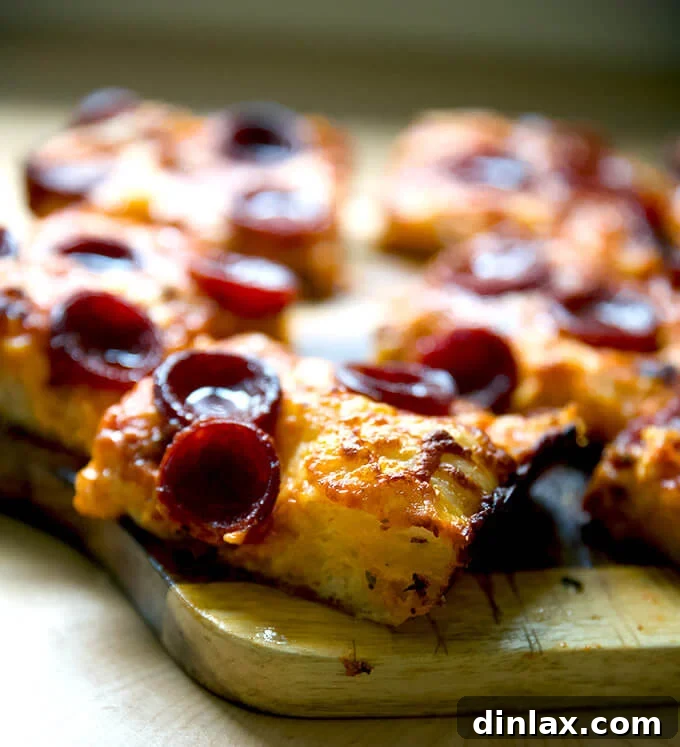 A mouthwatering Detroit-style pizza, showcasing its signature thick crust, caramelized edges, and generous toppings.