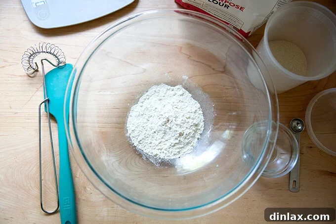 Ingredients for making a poolish: flour, water, and yeast, precisely measured and ready for mixing.