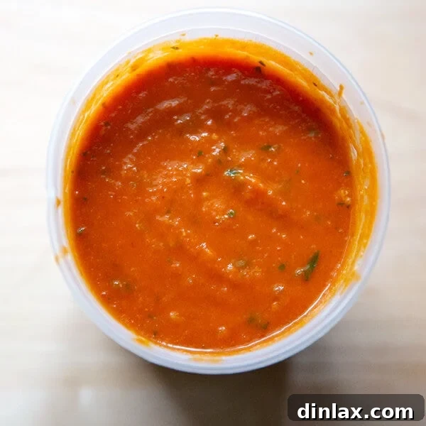 An overhead shot of homemade tomato sauce in a quart container.