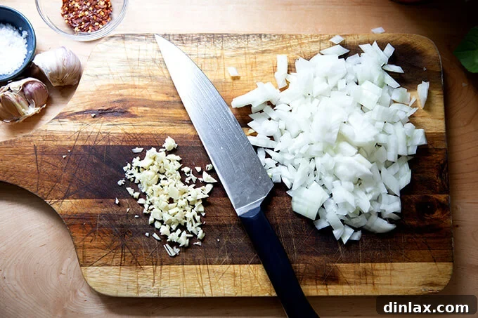 Pantry-Perfect Tomato Sauce in Minutes 4 Minced onions and garlic on a cutting board.