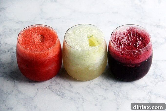 A refreshing trio of strawberry paloma slushies, garnished with lime.