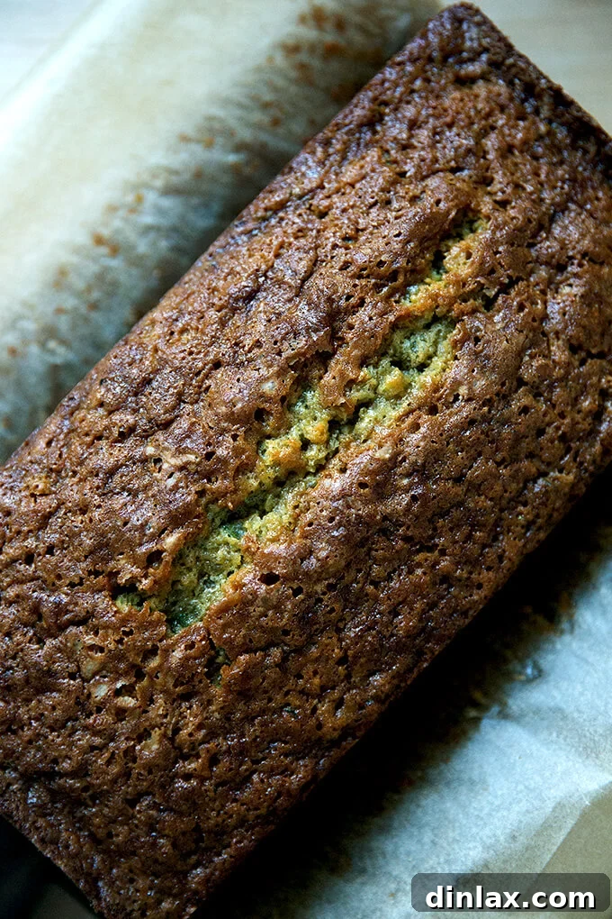 Decadently Moist Zucchini Bread Bliss 2 Freshly baked, golden-brown zucchini bread cooling on a wire rack, ready to be sliced.