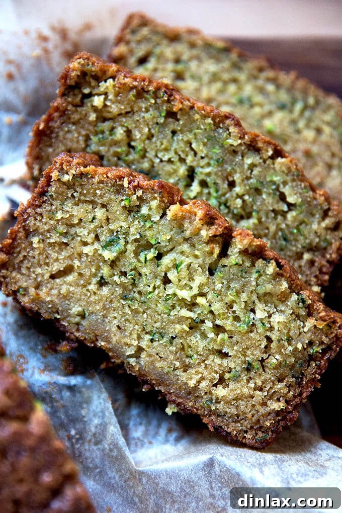Decadently Moist Zucchini Bread Bliss 12 Multiple slices of moist zucchini bread arranged artfully on a serving plate, highlighting its delicious texture.