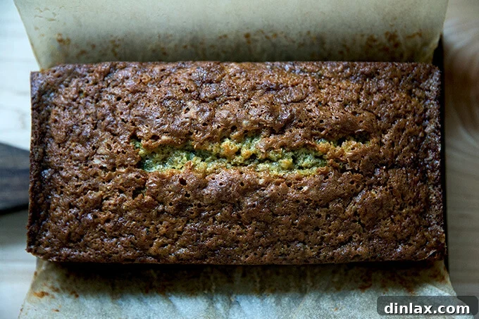 Decadently Moist Zucchini Bread Bliss 9 A freshly baked loaf of golden-brown zucchini bread with a beautifully cracked top, just removed from the oven.