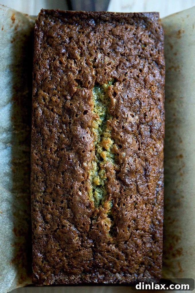 Decadently Moist Zucchini Bread Bliss 10 A perfectly baked loaf of zucchini bread, golden and inviting, cooling on a wire rack.